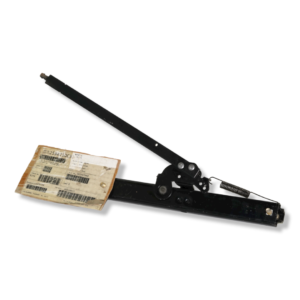 A black metal tool with a cardboard box on top of it.