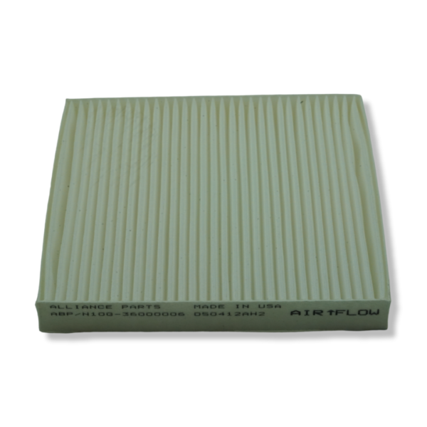 A green air filter is sitting on top of the floor.