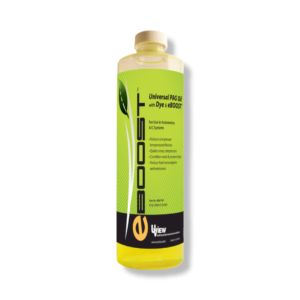 A bottle of yellow liquid with a green leaf on it.