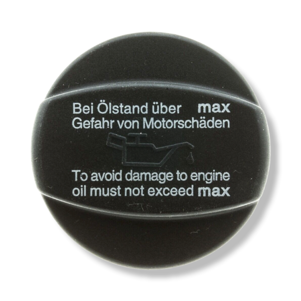 A black cap that says to avoid damage to engine oil must not exceed max.