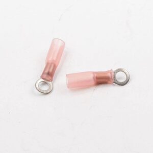 Two pink and brown electrical wire connectors on a white surface.