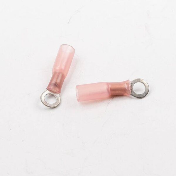 Two pink and brown electrical wire connectors on a white surface.