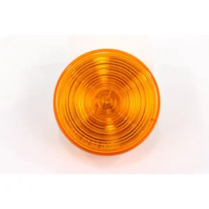 A yellow light is on and sitting on the ground.