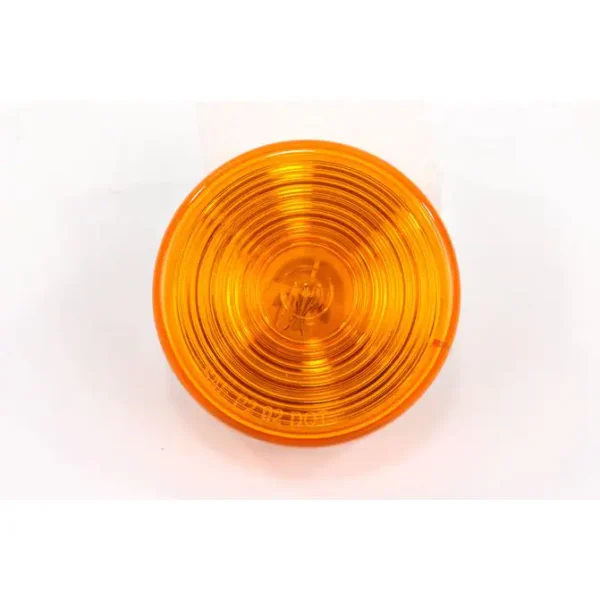 A yellow light is on and sitting on the ground.